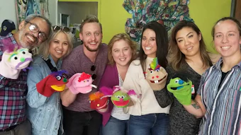 Mystery Trip plans custom, creative and spontaneous team-bonding events, such as a group puppet show.