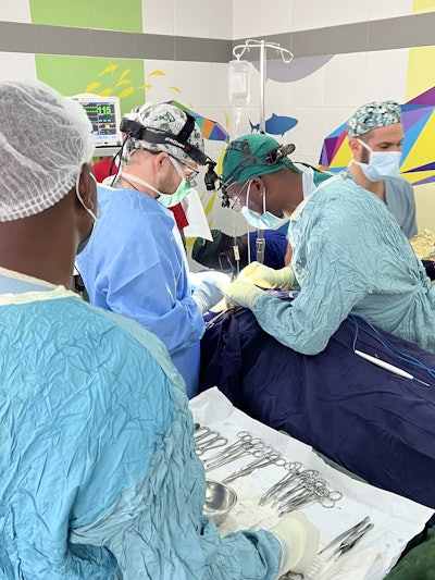 Jake Sims, DO, working with one of the Malawi-based residents.