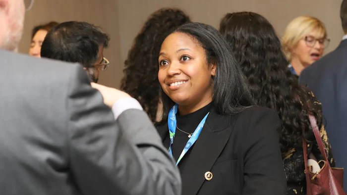 group of people networking, woman smiling at forefront