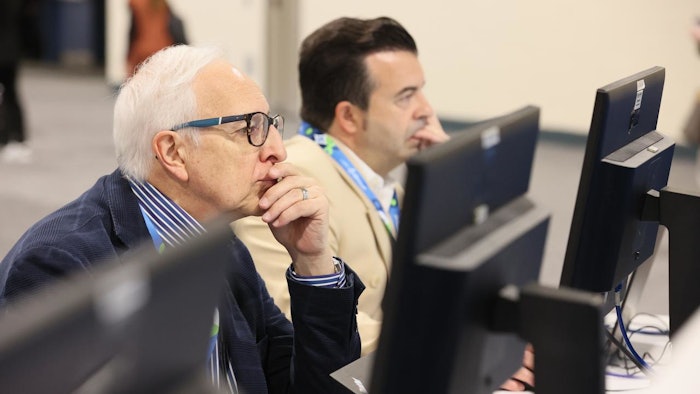 two dermatologists viewing online posters