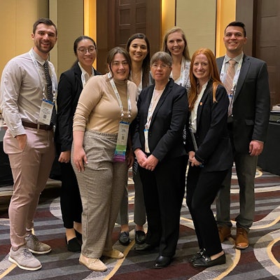 Michele Carr, DDS, MD, PhD (front center) with medical students from the University at Buffalo at the AAO-HNSF 2023 Annual Meeting & OTO Experience in Nashville, Tennessee. From left to right: Jeremy Walsh, Alison Ma, Emily Christie, Lauren DiNardo, Beatrice Bacon, Alexandra Corbin, and David Riccio.