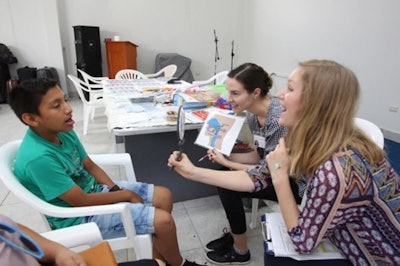 Speech therapists Chelsea Sommer, PhD, CCC-SLP, and Hannah Sanford-Keller, MS, CCC-SLP, carrying out an in-person speech therapy session.