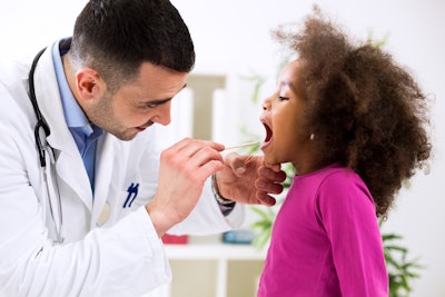 Doctor Checking Pediatric Throat