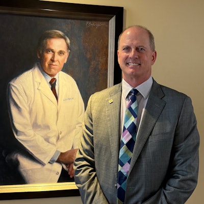 Dr. Backous poses next a portrait of his mentor, the late Bobby R. Alford, MD, former Baylor College of Medicine Chancellor and Distinguished Service Professor.
