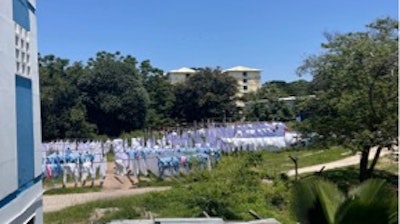 Hand-laundered bed sheets, gowns, and drapes drying on the lines at Bugando Hospital.