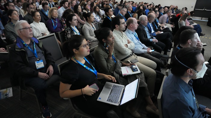 Attendees listen to session speakers.