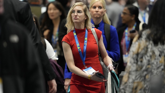 Crowded hallway of conference attendees walking to sessions.