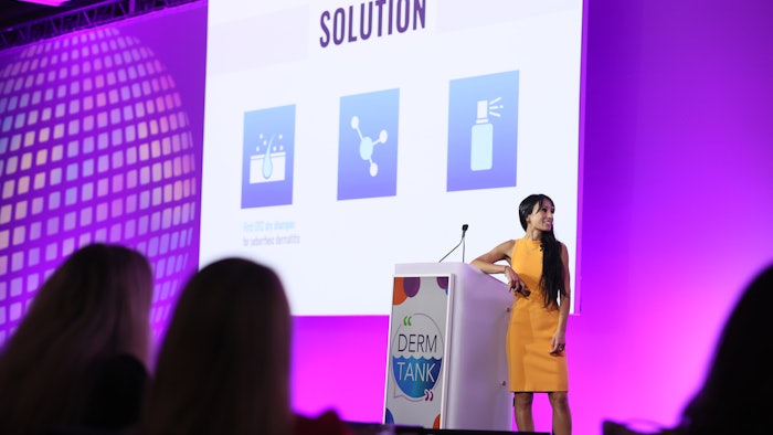 This photo is of Dr. Maryam Safaee presenting her Derm Tank idea in front of a big crowd.