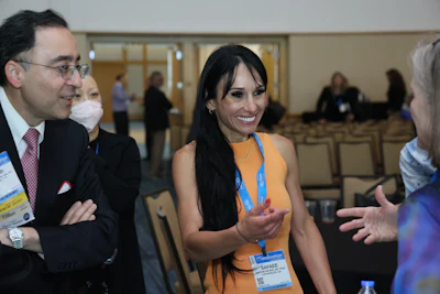 This is a picture of Dr. Maryam Safaee talking with fellow dermatologists at the Derm Tank presentation.