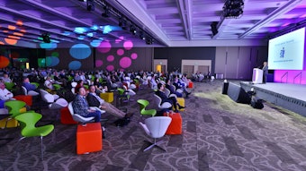 This is a wide shot of a big lecture in a colorful room at AAD Innovation Academy.