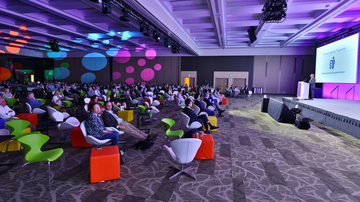 This is a wide shot of a big lecture in a colorful room at AAD Innovation Academy.