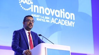This is a photo of Andrew F. Alexis, MD, MPH, FAAD standing at a podium and speaking at AAD Innovation Academy.