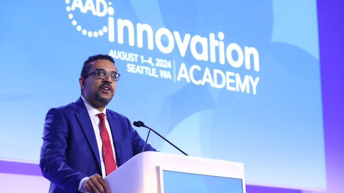 This is a photo of Andrew F. Alexis, MD, MPH, FAAD standing at a podium and speaking at AAD Innovation Academy.