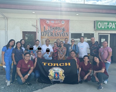 Members of the visiting care team together with local care providers and patients.