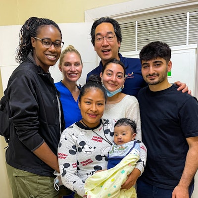 (Left to right) The author, Nneoma Wamkpah, MD, MSCI, Ashley Hilmes NP, John J. Chi, MD, and two volunteers visit with a patient after cleft lip repair in the postoperative clinic.