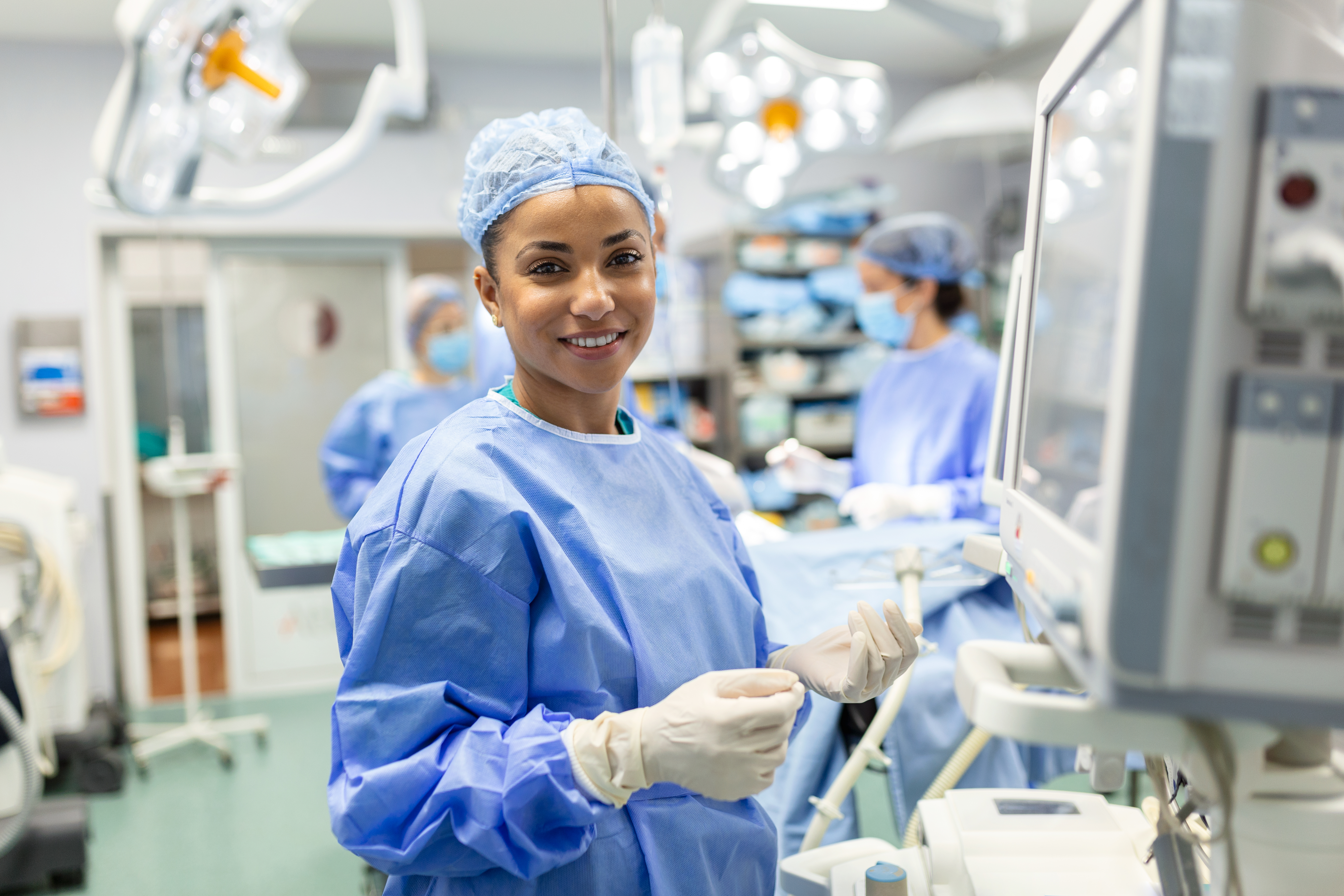 This is a photo of a Black, female anesthesiologist smiling.