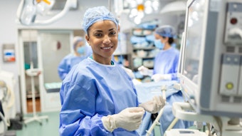 This is a photo of a Black, female anesthesiologist smiling.