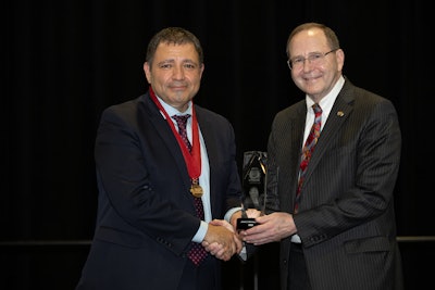 Dr. Denneny (right) receiving the Hall of Distinction Award during his induction with the class of 2022 at the AAO-HNSF 2022 Annual Meeting & OTO Experience.