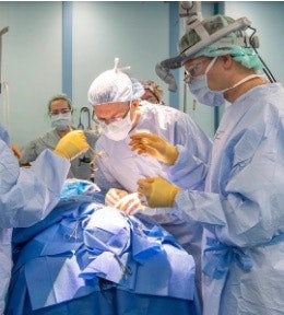 Captain Eamon O’Reilly, MD, and Lieutenant Commander Tanner Miller, MD, performing a bilateral cleft lip repair.