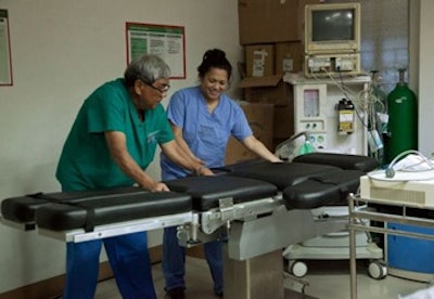 (Left to right) Renato “Noli” Zalamea, CRNA, and Dr. Nia Zalamea set up an operating room table in Carmona Cavite, near Manila.