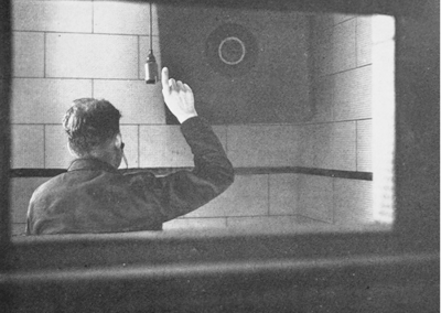 Figure 1. A patient in an aural rehabilitation center in a soundproof room listening to test tones using a hearing aid.3