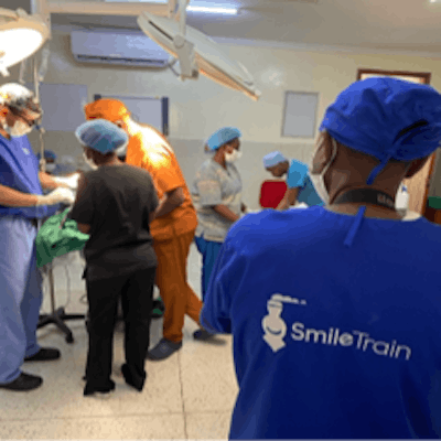 Dr. Christophel (far left), walks through cleft lip surgery with Kenyan plastic surgeons while a representative of Smile Train looks on.