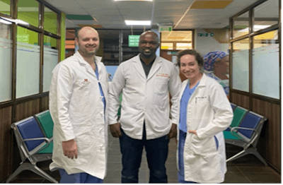 Left to right: Author Ryan H. Belcher, MD, MPH, with Kenyan plastic surgery resident Kiriga Maroa, MBChB, MMed, and Katelyn July O’Brien, MD, pause during surgical pre-op.