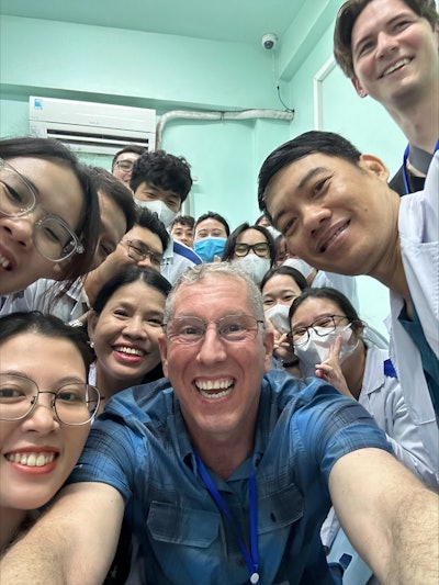 The author, Dr. Pine, and the young physicians and students stop to pose for a quick selfie during his latest trip to Vietnam.