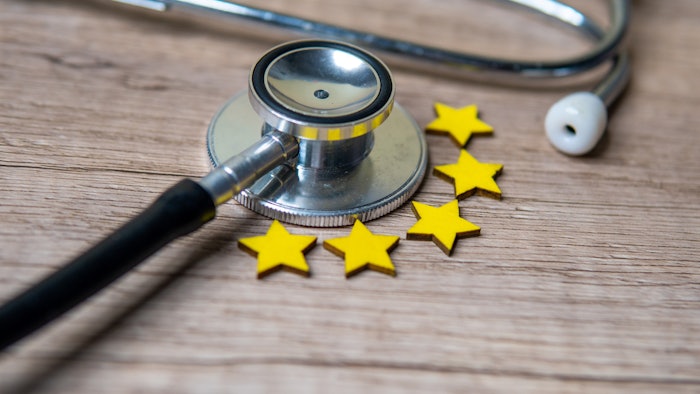 Image of a stethoscope on a table surrounded by five gold stars