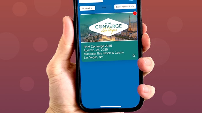 Photo of a hand holding a phone featuring the SHM Converge app.