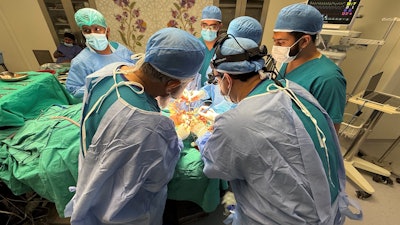 Dr. Ahmad operating with the Indus Hospital team.