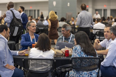 Attendees during the 2024 Annual Meeting connect with new acquaintances and life-long friends over lunch in the OTO EXPO.