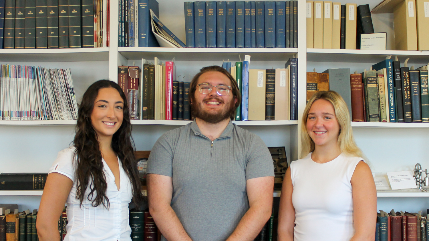 (Left to right): Emma, Ethan, and Piper in front of the Bulletin archives at the The John Q. Adams Center for the History of Otolaryngology-Head and Neck Surgery in Alexandria, Virginia.