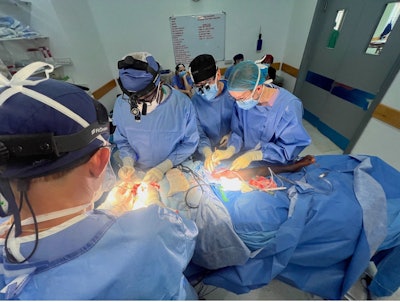 Dr. Zender works with Dr. Otiti to refine his microvascular skills, while Chief Resident Matthew Chu, MD, instructs surgical intern Emma Platt, MD, on suturing fundamentals.