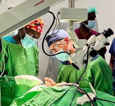 The author and Dr. Mercredi exchange roles while performing a revision canal wall down mastoidectomy under the watchful eye of Dr. Ayugi (red scrubs).