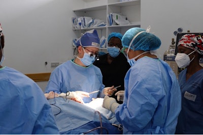 Dr. McKeon and Kiwoko Hospital intern Saghar Haghir suturing a skin graft following resection of a skin cancer.