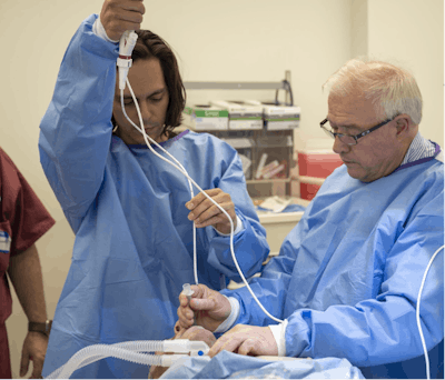 Two team members at AM24 coordinate a flexible bronchoscopy under pressure.