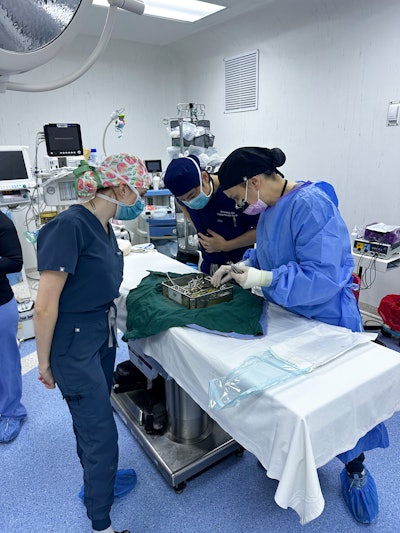Operating room in Corozal Community Hospital, with Dr. Tsung-yen Hsieh, Amanda Morrison, RN, and Colleen Smith, MA, preparing the OR and reviewing surgical kits and tools.