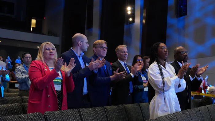 Diverse group of professionals applauding at a conference or event