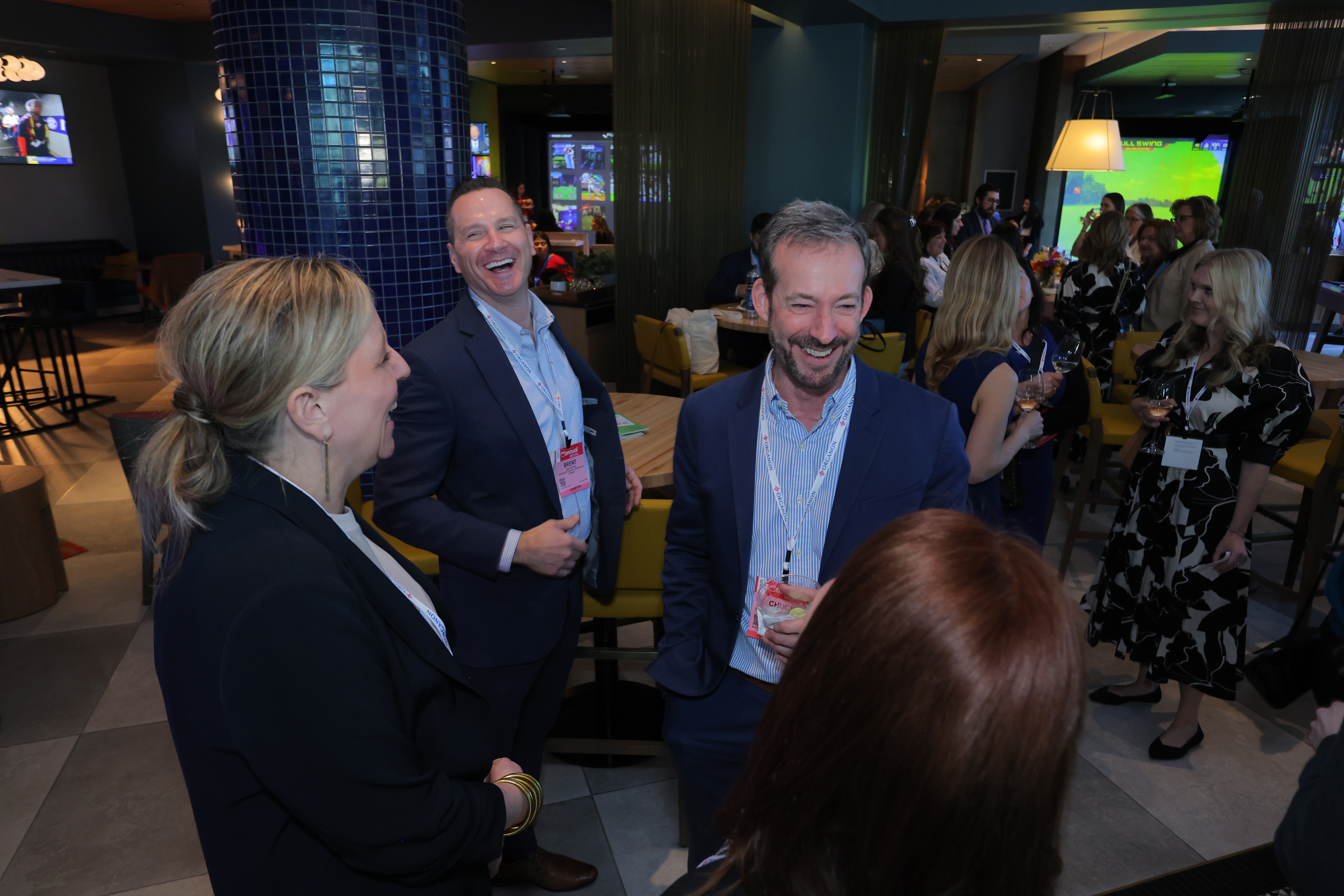 Professionals networking and laughing together in a modern event space