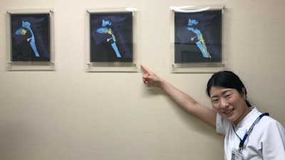 Dr. Inamoto with images of dynamic swallowing CTs in her clinic room.