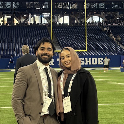 Uzair and his wife on the field at Lucas Oil Stadium during the President's Reception at the AAO-HNSF 2025 Annual Meeting & OTO EXPO.