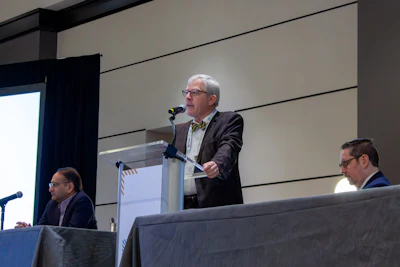 Gene Brown, MD, RPh, opens the 2026 OTO Forum with remarks along with Rahul K. Shah, MD, MBA (left) and Daniel R. Gold, MD (right).