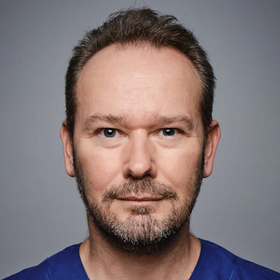 professional headshot of Professor Jonathan Clark, Director of Head and Neck Cancer Research at Chris O'Brien Lifehouse, in scrubs