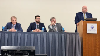 Four professionals at a panel discussion table with one speaker at podium displaying Anesthesiologists organization logo